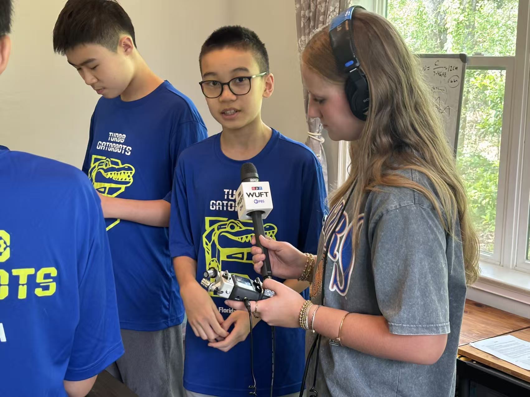 A Turbo Gatorbots teammate sharing the team's robotics journey during an interview