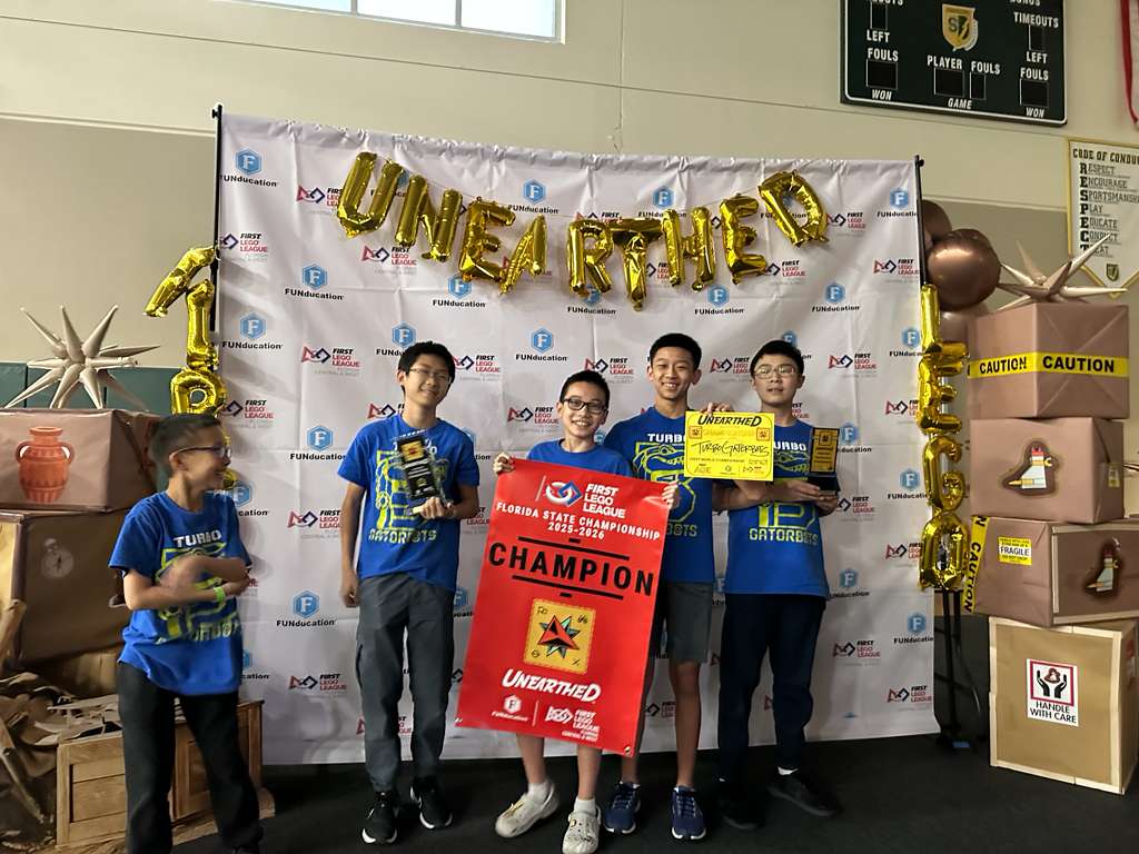 Turbo Gatorbots holding their Florida state championship banner